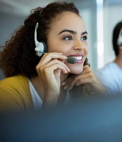 Customer service representative wearing headset at Host Merchant Services call center.